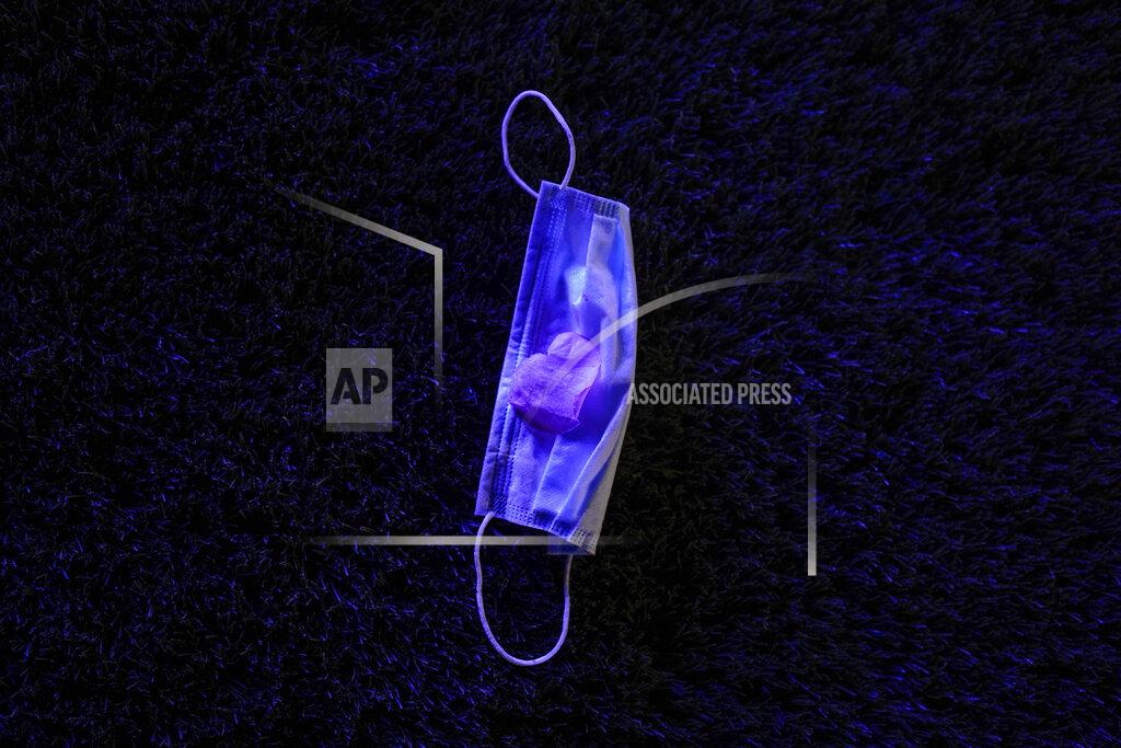 Paul Ratje A surgical mask lies on the ground during a prom held at the Grace Gardens Event Center in El Paso, Texas on Friday, May 7, 2021. Around 2,000 attended the outdoor event at the private venue after local school districts announced they would not host proms this year. Tickets cost $45. (AP Photo/Paul Ratje)