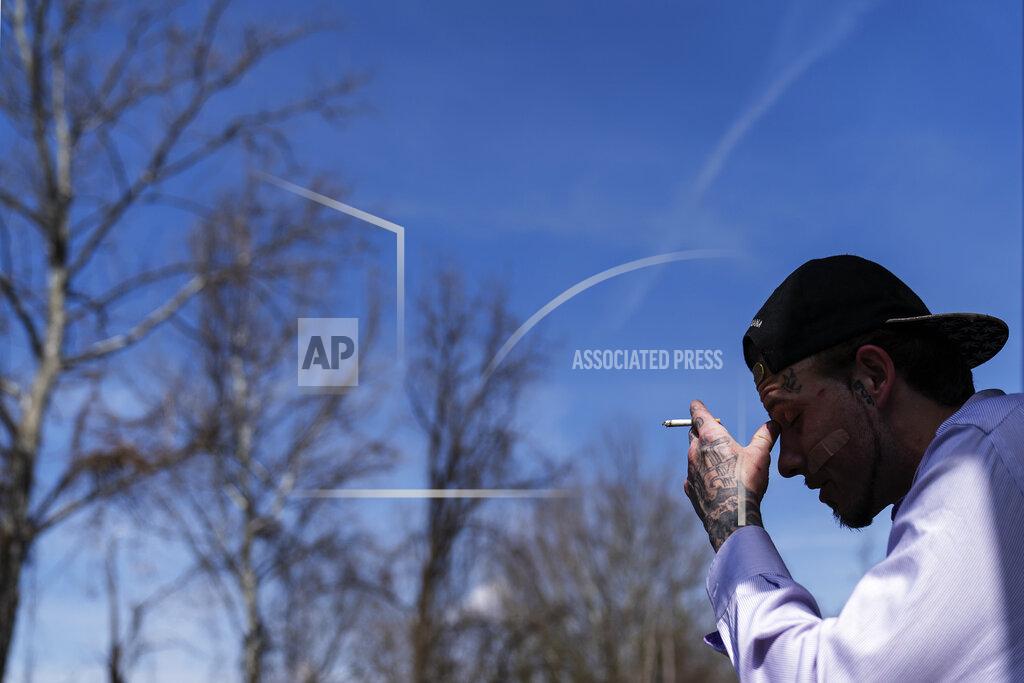 David Goldman Joshua Messer, 29, sits on the front stoop of his aunt's house where he is currently staying days after overdosing Tuesday, March 16, 2021, in Huntington, W.Va. Messer was a high school basketball star, heading to college on a scholarship. He still brags that he was such a star athlete he once met the governor. But addiction took hold, to alcohol and pills. "I let my family down, now I'm trying to get it back together. I look at some people and it's sad how they look," he said. "I'm starting to look like that. I'm not better than other people. But I'm better than letting something take control of my life. I feel like I should be better than this." (AP Photo/David Goldman)