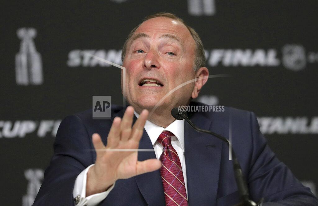Charles Krupa FILE - In this May 27, 2019, file photo, NHL Commissioner Gary Bettman speaks to the media before Game 1 of the NHL hockey Stanley Cup Finals between the St. Louis Blues and the Boston Bruins, in Boston. The NHL is one step closer to returning. Bettman unveiled a 24-team straight to playoffs format the league will use if it can clear the other hurdles to resume its season. Under the plan approved last week by players and agreed to by the NHL, the top four teams in each conference will play for seeding while the other 16 face off in best-of-five series to determine the field to vie for the Stanley Cup .(AP Photo/Charles Krupa, File)