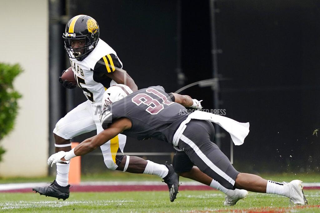 Rogelio V. Solis Arkansas-Pine Bluff running back Mattias Clark (45) evades a tackle attempt by Alabama A&M safety Jonathan Struggs (31) during the second half of the Southwestern Athletic Conference Championship NCAA college football game, Saturday, May 1, 2021, in Jackson, Miss. Alabama A&M won 40-33. (AP Photo/Rogelio V. Solis)