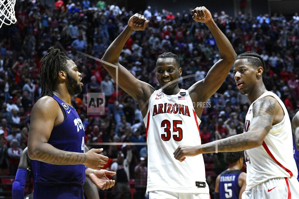 Denis Poroy Arizona center Christian Koloko (35) reacts as Arizona guard Dalen Terry, right, stands across from TCU center Eddie Lampkin, left, at the end of overtime in a second-round NCAA college basketball tournament game, Sunday, March 20, 2022, in San Diego. Arizona won 85-80 in overtime. (AP Photo/Denis Poroy)