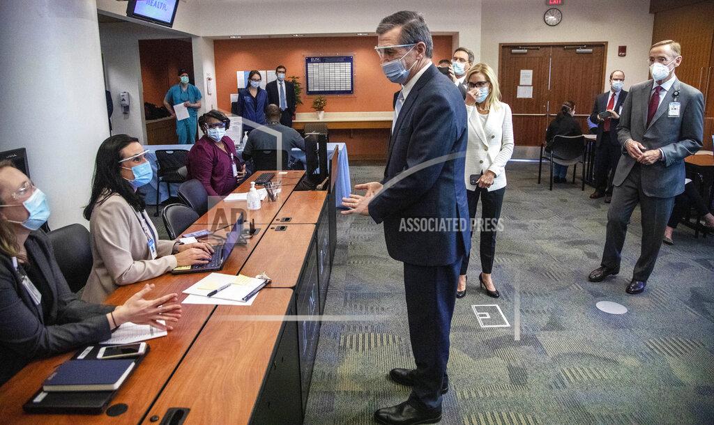 Gov. Roy Cooper thanks healthcare workers during a visit to UNC Health in Chapel Hill, N.C., Thursday, Dec. 17, 2020, where frontline healthcare workers are among some of the first recipients of the Pfizer COVID-19 vaccine. (Travis Long/The News & Observer via AP)