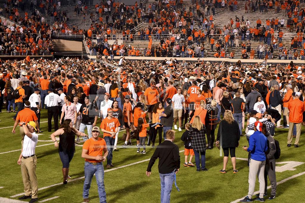 Brody Schmidt Oklahoma State fans take to the field following an NCAA college football game against Texas, in Stillwater, Okla., Saturday, Oct. 27, 2018. Oklahoma State defeated Texas 38-35. (AP Photo/Brody Schmidt)