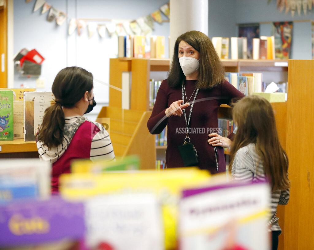 Brian Hill Emerson Elementary School librarian Lauren Blanford Wednesday Feb. 24, 2021 in Elmhurst, Ill. (Brian Hill/Daily Herald via AP)