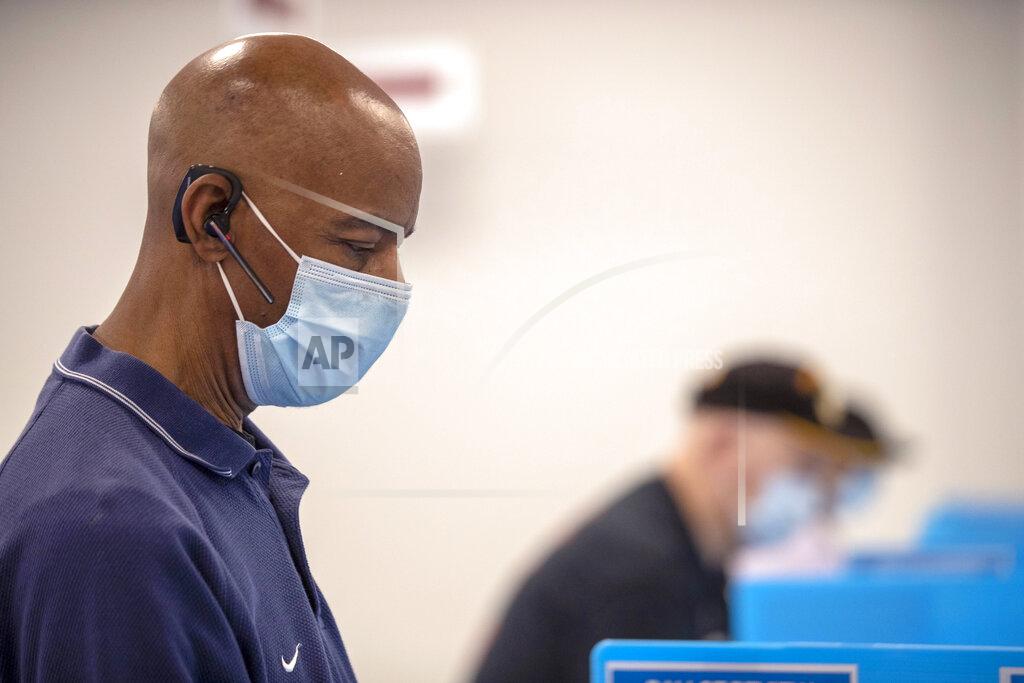 Alyssa Pointer FILE - In this May 18, 2020, file photo, Charles McClendon, of Snellville, votes in Georgia's primary election at the Gwinnett County Voter Registration and Elections Office in Lawrenceville, Ga. Early voting began that day. (Alyssa Pointer/Atlanta Journal-Constitution via AP, File)