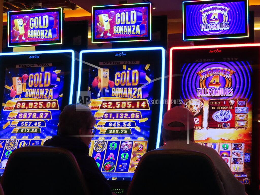 Wayne Parry People sit at gambler play slot machines at the Tropicana casino in Atlantic City, N.J., on May 12, 2022. Figures released by New Jersey gambling regulators on Monday, May 23, 2022, show the Atlantic City casinos collectively posted a gross operating profit of $155.6 million in the first quarter of this year. (AP Photo/Wayne Parry)