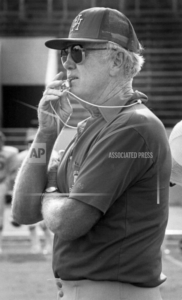 FILE - In this 1981 file photo, Houston coach Bill Yeoman watches the football team practice in Houston. Yeoman, the longtime Houston football coach who led the Cougars to four Southwest Conference titles and a school-record 160 victories, has died. He was 92. The university announced the death Wednesday, Aug. 12, 2020, without providing details. Son, Bill Jr., told ESPN his father died of pneumonia and kidney failure. (Larry Reese/Houston Chronicle via AP, File)