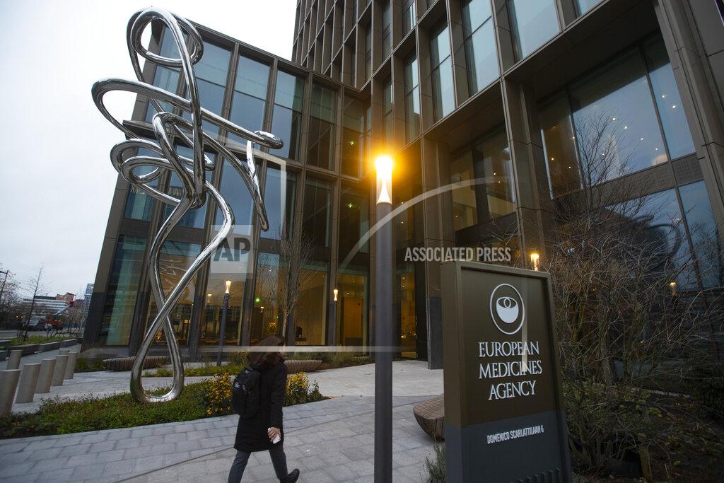 A person enters the European Medicines Agency in Amsterdam, Netherlands, Monday, Dec. 21, 2020, where the EMA's human medicines committee is holding an exceptional, fully virtual, meeting to conclude the evaluation of the Pfizer-BioNTech COVID-19 vaccine. (AP Photo/Peter Dejong)
