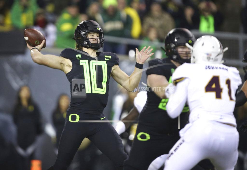 Chris Pietsch Oregon quarterback Justin Herbert, left, throws down field against Arizona State during the third quarter of an NCAA college football game Saturday, Nov. 17, 2018, in Eugene, Ore. (AP Photo/Chris Pietsch)