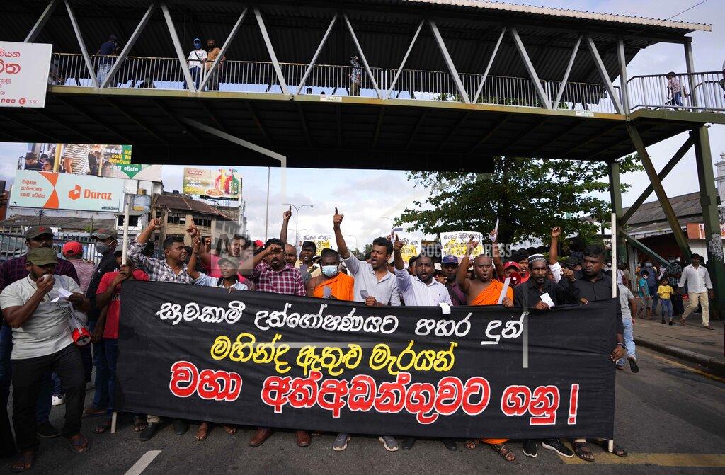 Eranga Jayawardena Members of Socialist Youth Union shout slogans and march towards Sri Lanka's police headquarters carrying a banner demanding the arrest of former prime minister Mahinda Rajapkasa for allegedly assaulting anti government protesters in Colombo, Sri Lanka, Monday, May 16, 2022. (AP Photo/Eranga Jayawardena)