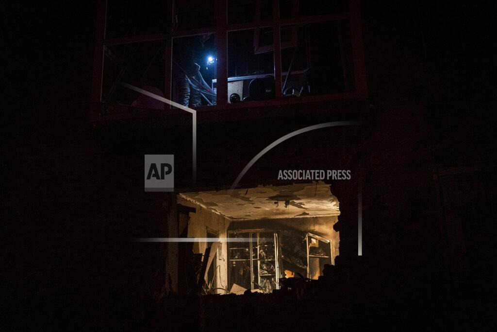 Bernat Armangue A resident look at the damage in a building after a Russian strike in Kherson, southern Ukraine, Thursday, Nov. 24, 2022. (AP Photo/Bernat Armangue)