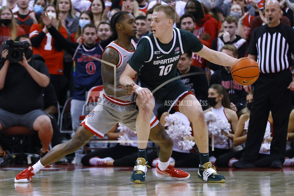 Jay Laprete Michigan State's Joey Hauser, right, tries to drive past Ohio State's Cedric Russell during the second half of an NCAA college basketball game Thursday, March 3, 2022, in Columbus, Ohio. (AP Photo/Jay LaPrete)