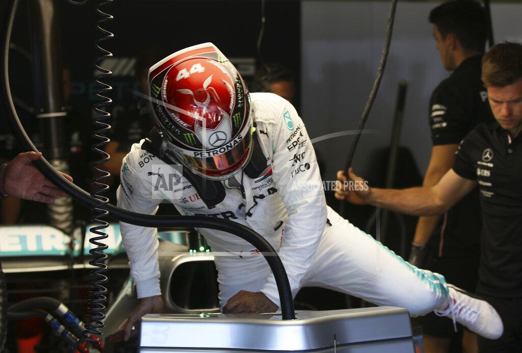 Ronald Zak Mercedes driver Lewis Hamilton of Britain gets into his car cockpit during the first free practice session for the Austrian Formula One Grand Prix at the Red Bull Ring racetrack in Spielberg, southern Austria, Friday, June 28, 2019. The race will be held on Sunday. (AP Photo/Ronald Zak)