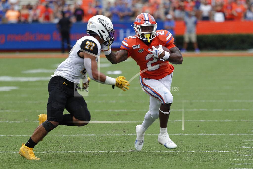 John Raoux Florida running back Lamical Perine, right, tries to avoid Towson safety S.J. Brown II (27) during the first half of an NCAA college football game, Saturday, Sept. 28, 2019, in Gainesville, Fla. (AP Photo/John Raoux)