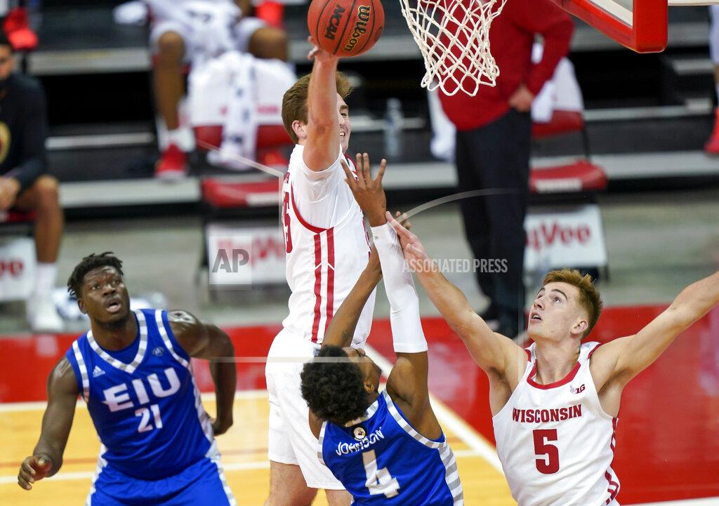 Andy Manis Wisconsin's Nate Reuvers, top left, and Carter Higginbottom defend on a shot by Eastern Illinois' Marvin Johnson (4) during the first half of an NCAA college basketball game Wednesday, Nov. 25, 2020, in Madison, Wis. (AP Photo/Andy Manis)