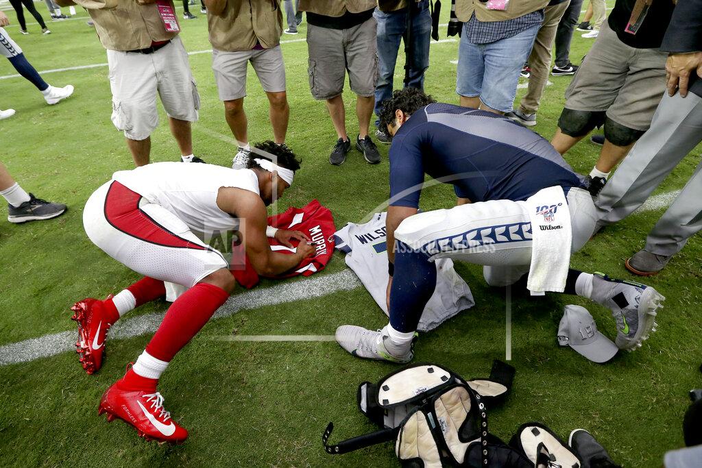Ross D. Franklin Seattle Seahawks quarterback Russell Wilson, right, and Arizona Cardinals quarterback Kyler Murray, left, exchange jerseys after an NFL football game, Sunday, Sept. 29, 2019, in Glendale, Ariz. (AP Photo/Ross D. Franklin)