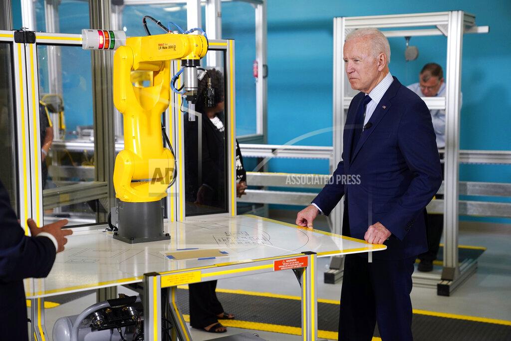 Evan Vucci President Joe Biden listens during a tour of the Cuyahoga Community College Manufacturing Technology Center, Thursday, May 27, 2021, in Cleveland. (AP Photo/Evan Vucci)
