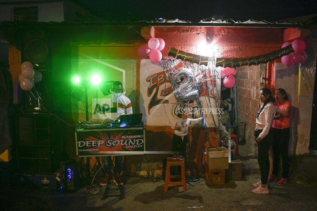 Matias Delacroix A man plays music during New Year's Eve celebrations at the 23 de Enero neighborhood in Caracas, Venezuela, late Thursday, Dec. 31, 2020, amid the new coronavirus pandemic. (AP Photo/Matias Delacroix)