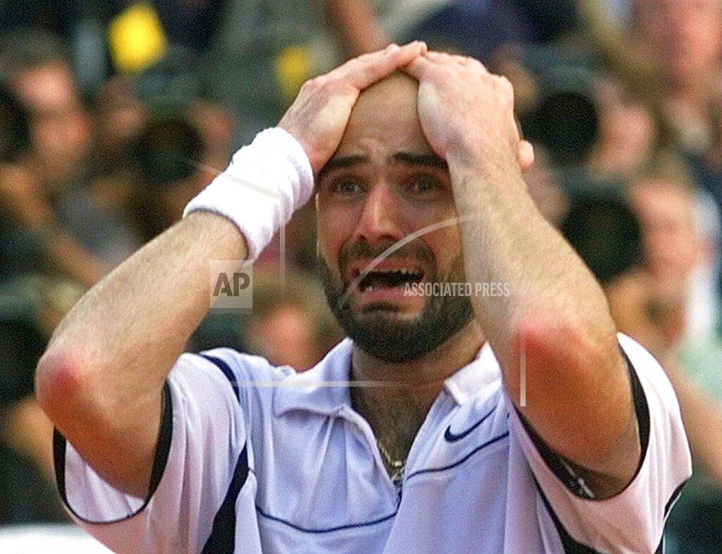Laurent Rebours FILE - In this June 6, 1999, file photo, 13th-seeded Andre Agassi reacts after he defeated Andrei Medvedev 1-6, 2-6, 6-4, 6-3, 6-4 in the men's final tennis match at the French Open at Roland Garros stadium in Paris. Agassi forever changed the way his career would be viewed by completing a career Grand Slam. (AP Photo/Laurent Rebours, File)