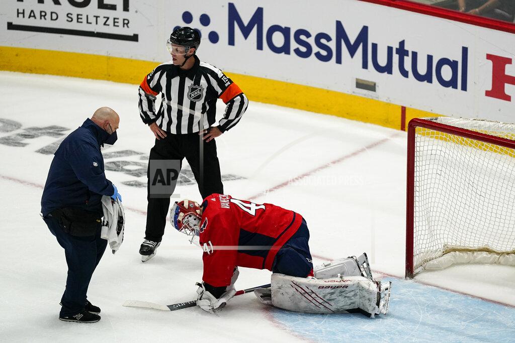 Alex Brandon Washington Capitals goaltender Vitek Vanecek (41) receives attention during the first period of Game 1 of th team's NHL hockey Stanley Cup first-round playoff series against the Boston Bruins, Saturday, May 15, 2021, in Washington. Vanecek left the game. (AP Photo/Alex Brandon)