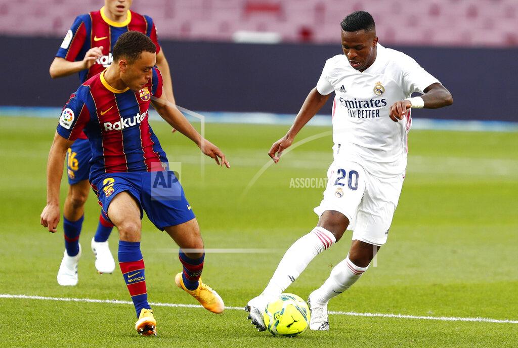 Joan Monfort Real Madrid's Vinicius Junior fights for the ball against Barcelona's Sergino Dest during the Spanish La Liga soccer match between FC Barcelona and Real Madrid at the Camp Nou stadium in Barcelona, Spain, Saturday, Oct. 24, 2020. (AP Photo/Joan Monfort)