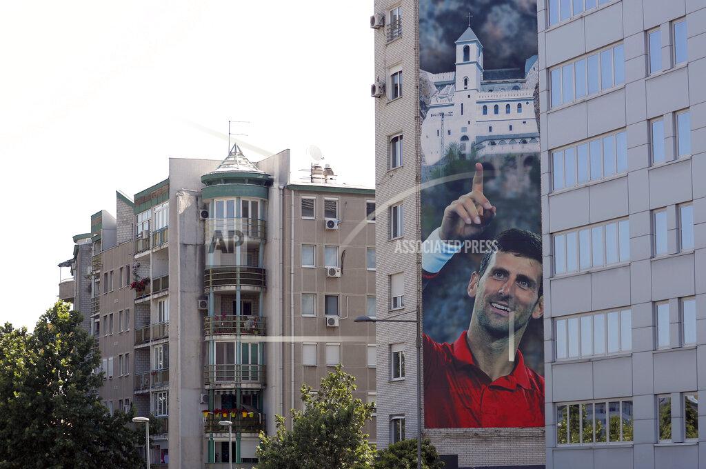 Darko Vojinovic A billboard depicting Serbian tennis player Novak Djokovic and the Christian Orthodox monastery of Ostrog is seen on a building in Belgrade, Serbia, Wednesday, June 24, 2020. Djokovic has tested positive for the coronavirus after taking part in a tennis exhibition series he organized in Serbia and Croatia. The top-ranked Serb is the fourth player to test positive for the virus after first playing in Belgrade and then again last weekend in Zadar, Croatia.(AP Photo/Darko Vojinovic)