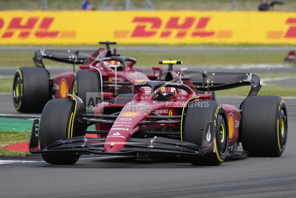 Frank Augstein Ferrari driver Carlos Sainz of Spain, foreground, and Ferrari driver Charles Leclerc of Monaco steer thier cars during the British Formula One Grand Prix at the Silverstone circuit, in Silverstone, England, Sunday, July 3, 2022. (AP Photo/Frank Augstein)