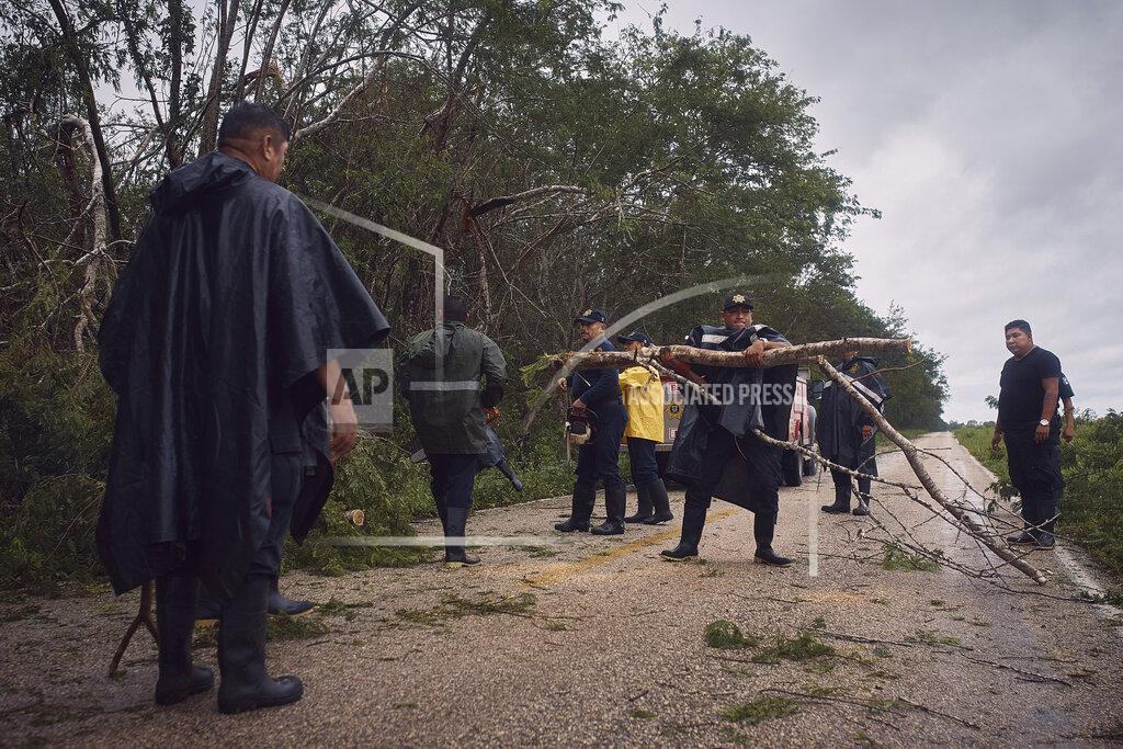 Andres Kudacki Police clear debris from a road after the passing of Hurricane Delta in Tizimin, Mexico, Wednesday, Oct. 7, 2020. Hurricane Delta made landfall Wednesday just south of the Mexican resort of Cancun as a Category 2 storm, downing trees and knocking out power to some resorts along the northeastern coast of the Yucatan Peninsula. (AP Photo/Andres Kudacki)