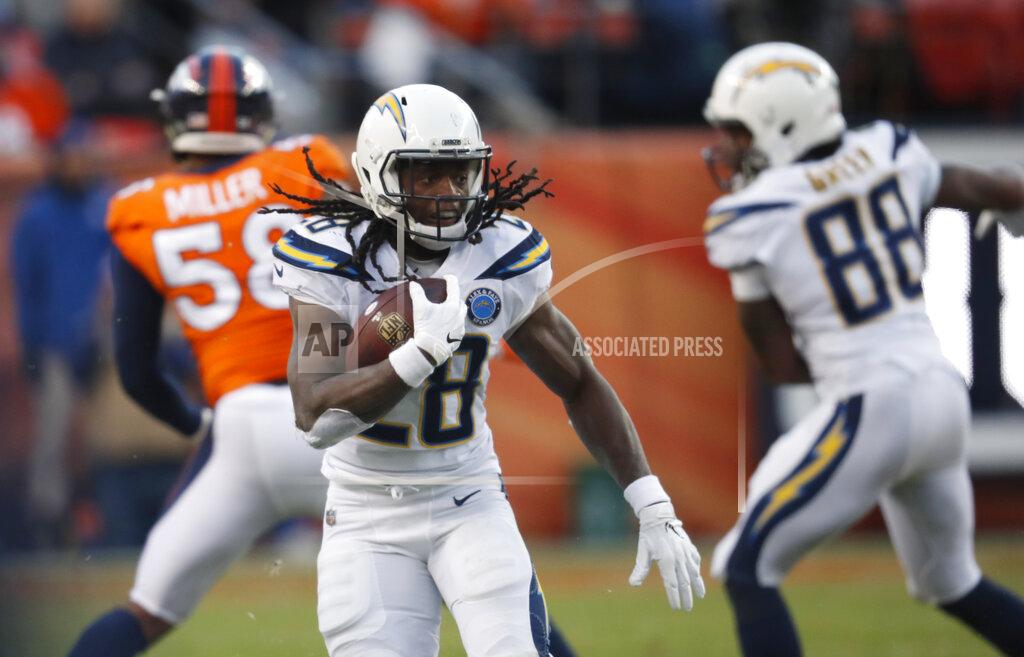 FILE - In this Dec. 30, 2018, file photo, Los Angeles Chargers running back Melvin Gordon rushes during the second half of the team's NFL football game against the Denver Broncos in Denver. A person familiar with the situation says Gordon will end his holdout and report to the Los Angeles Chargers on Thursday, Sept. 26. The person spoke to The Associated Press on condition of anonymity Wednesday because he wasn't at liberty to publicly discuss the situation. (AP Photo/David Zalubowski, File)