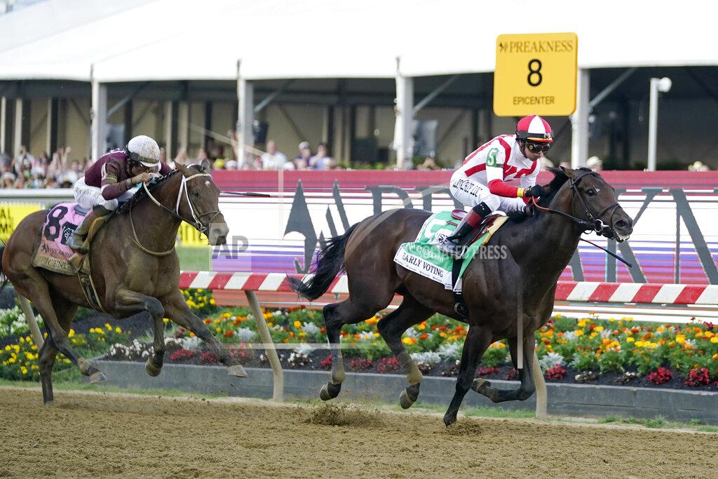 Julio Cortez Jose Ortiz, right, atop Early Voting, heads to the finish line with Joel Rosario, atop Epicenter, at his tail before winning the 147th running of the Preakness Stakes horse race at Pimlico Race Course, Saturday, May 21, 2022, in Baltimore. (AP Photo/Julio Cortez)
