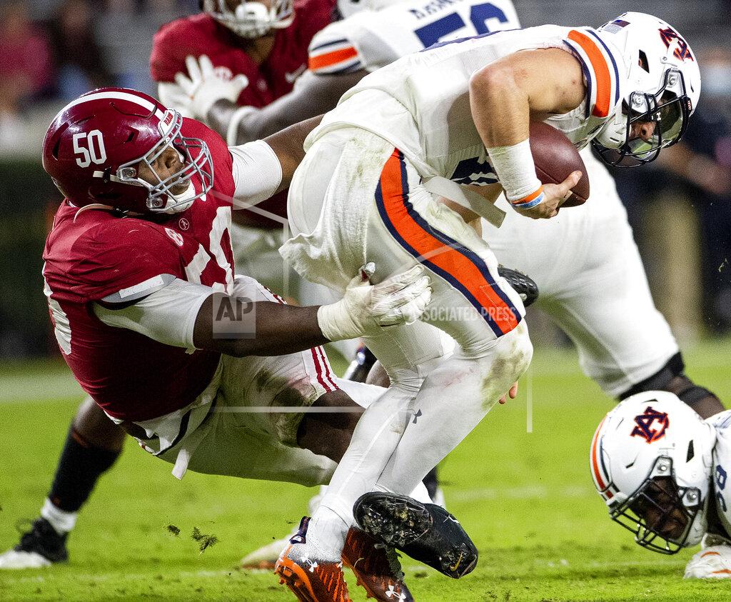 Mickey Welsh Alabama defensive lineman Tim Smith (50) hits Auburn quarterback Bo Nix (10) during an NCAA college football game Saturday, Nov. 28, 2020, in Tuscaloosa, Ala. (Mickey Welsh/The Montgomery Advertiser via AP)