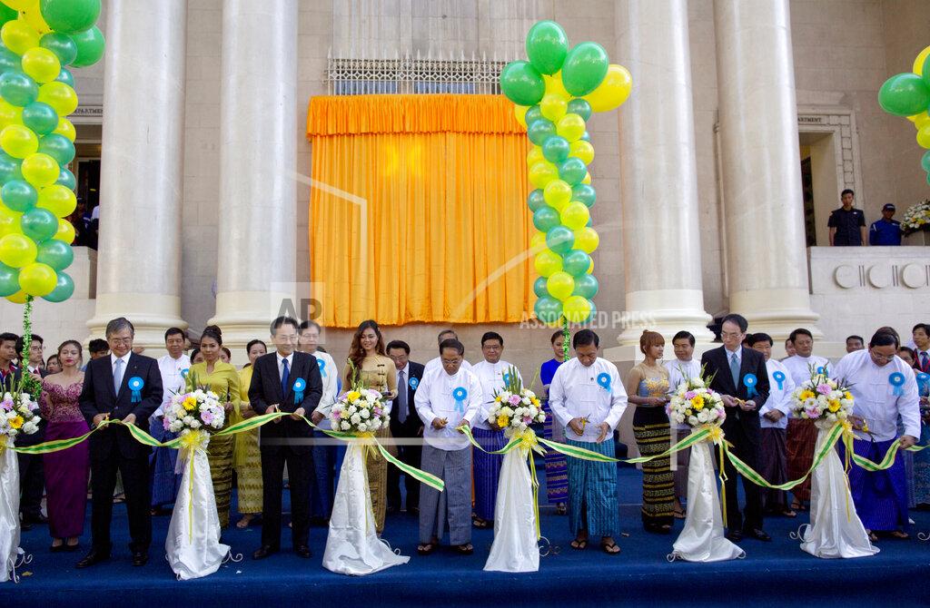 Gemunu Amarasinghe FILE - In this Dec. 9, 2015, file photo, senior government officials and foreign investors cut a ribbon during the opening ceremony of the Yangon Stock Exchange in Yangon, Myanmar. The military coup in Myanmar is unlikely to do the country’s struggling economy any good at all. The country once considered a promising last frontier has languished as the pandemic added to its challenges. (AP Photo/Gemunu Amarasinghe, File)