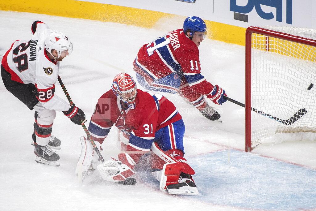 Graham Hughes Montreal Canadiens goaltender Carey Price (31) is scored against by Ottawa Senators' Connor Brown (28) as Canadiens' Brendan Gallagher looks for a rebound during first-period NHL hockey game action in Montreal, Saturday, April 3, 2021. (Graham Hughes/The Canadian Press via AP)