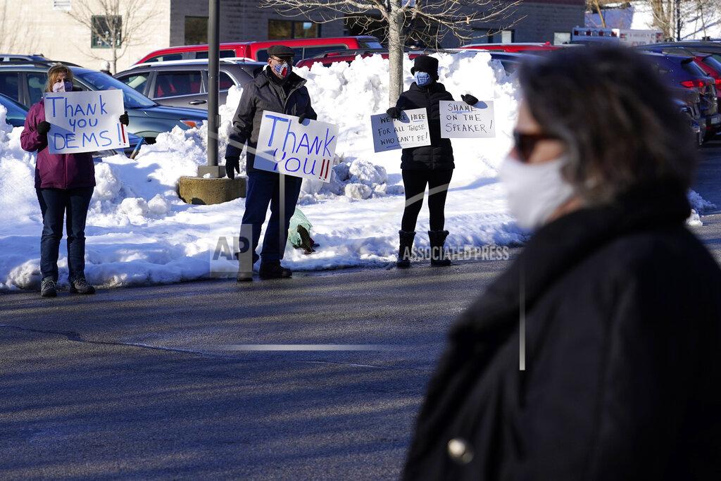 Charles Krupa Protestors support Democrat legislators, who arrive for a New Hampshire House of Representatives legislative session held at NH Sportsplex, due to the coronavirus, Wednesday, Feb. 24, 2021, in Bedford, N.H. (AP Photo/Charles Krupa)