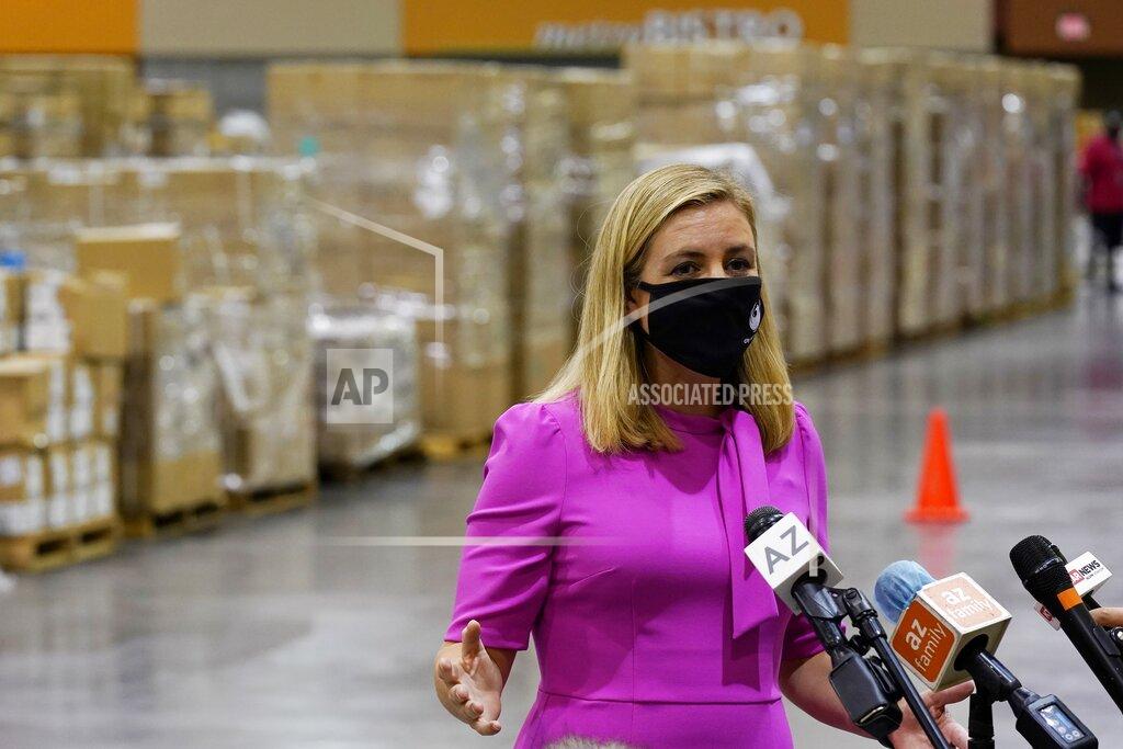 Ross D. Franklin Phoenix Mayor Kate Gallego announces the arrival of more than one million pieces of PPE to help Phoenix schools reopen for the 2020-2021 school year as pallets fill a Phoenix Convention Center hall, Tuesday, Sept. 8, 2020, in Phoenix, as the city begins to ship the pallets out to schools. (AP Photo/Ross D. Franklin)