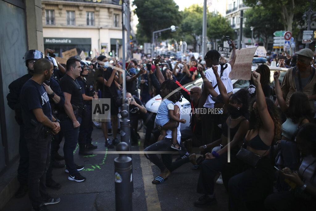 Protesters face police officers during a demonstration Tuesday, June 2, 2020 in Marseille, southern France. Thousands of people defied a police ban and converged on the main Paris courthouse for a demonstration to show solidarity with U.S. protesters and denounce the death of a black man in French police custody. (AP Photo/Daniel Cole)