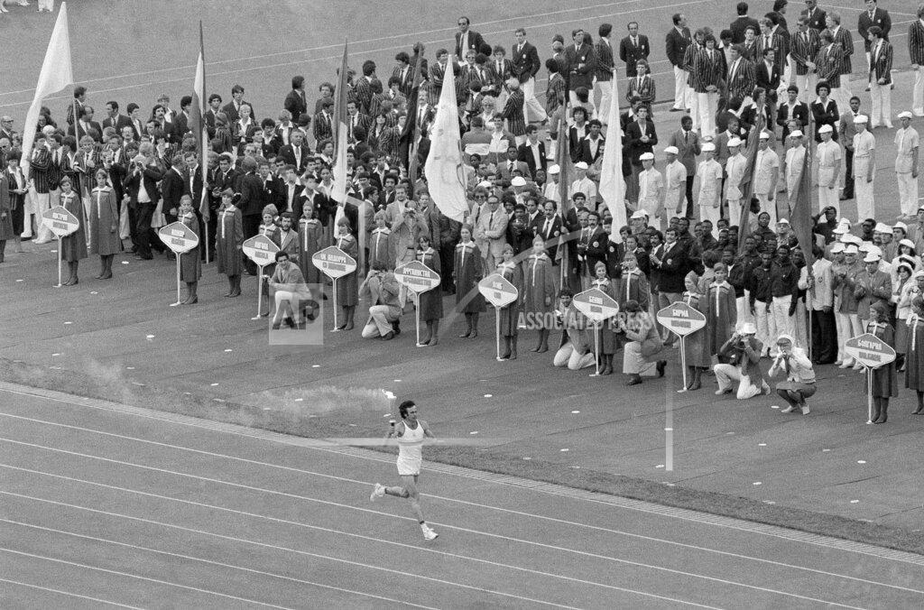 Anonymous Soviet athlete Sergei Belov runs with the Olympic flame past the Olympic team from Afghanistan during opening ceremonies of the 1980 Summer Olympic Games in Moscow on Saturday, July 20, 1980. A number of teams boycotted the ceremony to protest Soviet intervention into Afghanistan. (AP Photo)