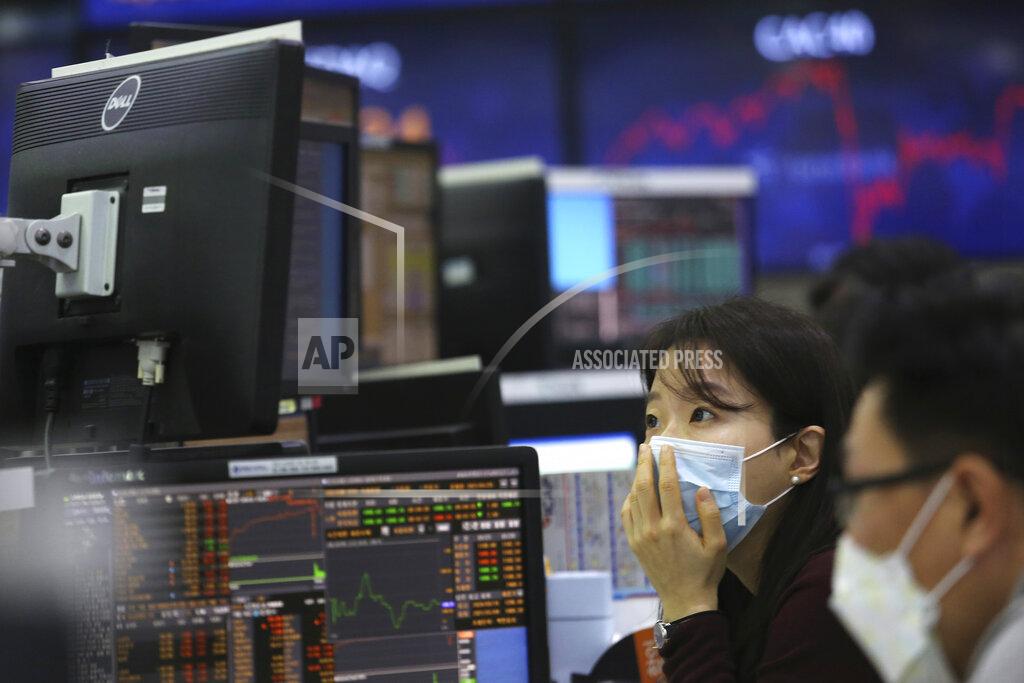 Ahn Young-Joon A currency trader watches monitors at the foreign exchange dealing room of the KEB Hana Bank headquarters in Seoul, South Korea, Thursday, Jan. 21, 2021. Asian shares rose Thursday on optimism over the new U.S. administration that earlier set off a rally on Wall Street. (AP Photo/Ahn Young-joon)