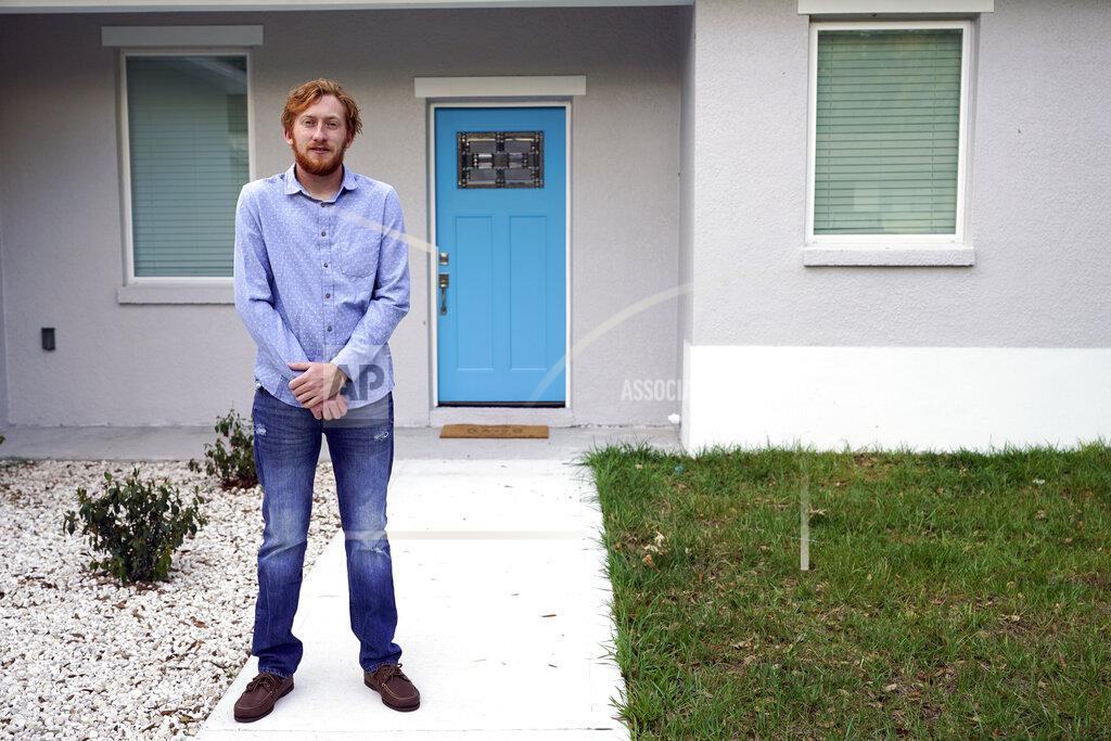 John Raoux First-time buyer Kevin Muglach stands in front of his new home, Tuesday, April 6, 2021, in Orange City, Fla. Homebuyers are facing the most competitive U.S. housing market in decades this spring, as surging prices and a record-low number of homes for sale narrow the already difficult path to home ownership for many Americans. (AP Photo/John Raoux)