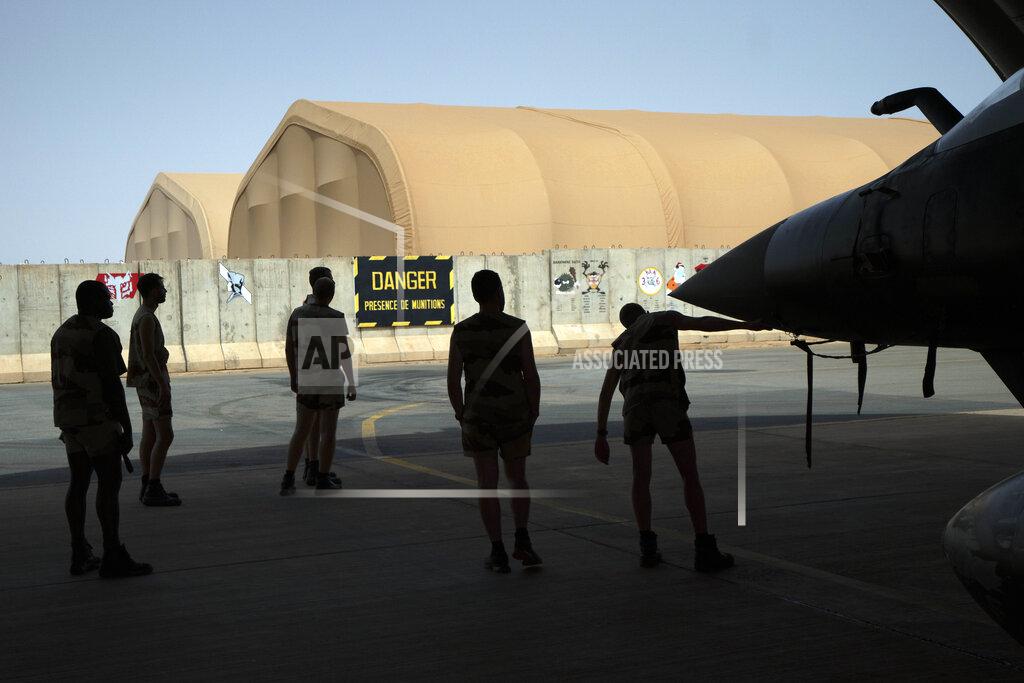 Uncredited French Barkhane Air Force mechanics maintain a Mirage 2000 on the Niamey, Niger base June 5, 2021. French President Emmanuel Macron announced at a press conference Thursday June 10, 2021 That operation Barkhane would end and be replaced by support for local partners and counter terrorism. (AP Photo/Jerome Delay)