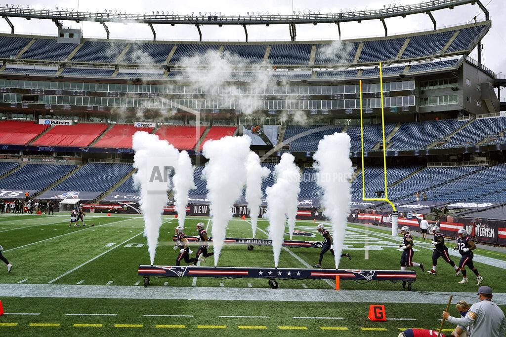Charles Krupa The New England Patriots run onto the field surrounded by empty Gillette Stadium seats, absent of fans due to the COVID-19 pandemic ,before an NFL football game against the Las Vegas Raiders, Sunday, Sept. 27, 2020, in Foxborough, Mass. (AP Photo/Charles Krupa)