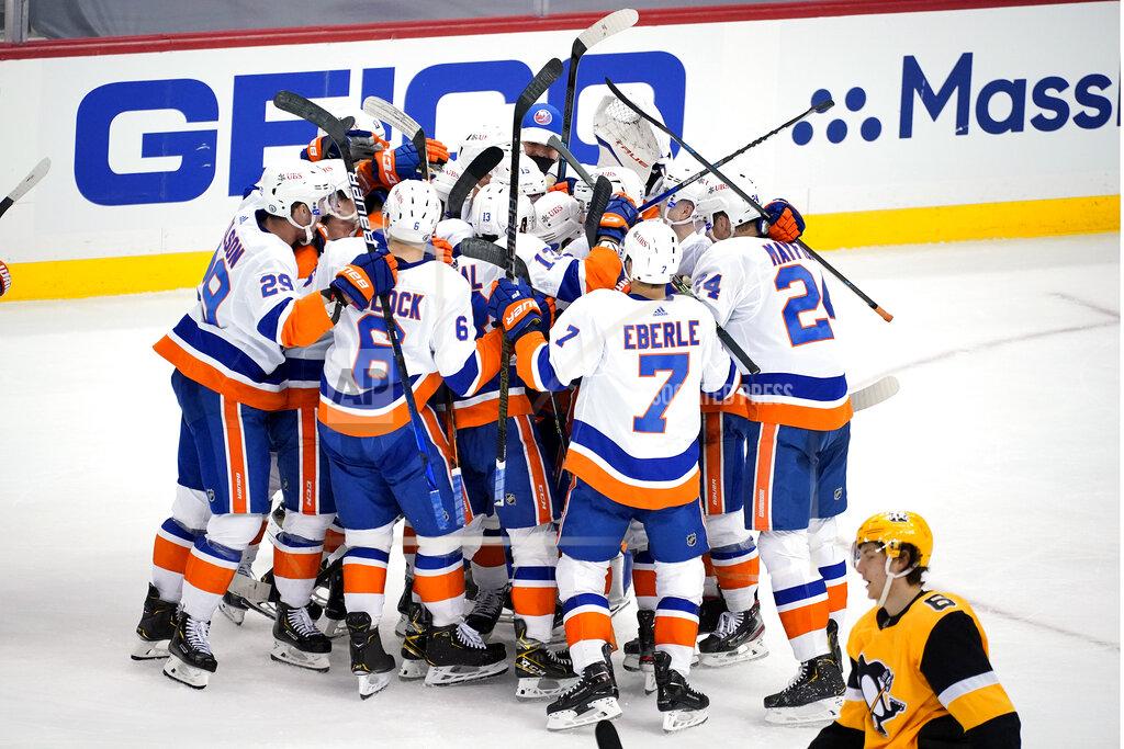 Gene J. Puskar Pittsburgh Penguins' John Marino (6) skates to the locker room as the New York Islanders celebrate a game-winning overtime goal by Kyle Palmieri in Game 1 of an NHL hockey Stanley Cup first-round playoff series in Pittsburgh, Sunday, May 16, 2021. The Islanders won 4-3. (AP Photo/Gene J. Puskar)