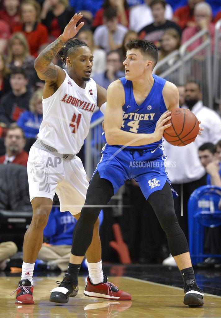 Timothy D. Easley Kentucky guard Tyler Herro (14) looks for help from the defense of Louisville guard Khwan Fore (4) during the second half of an NCAA college basketball game in Louisville, Ky., Saturday, Dec. 29, 2018. Kentucky won 71-58. (AP Photo/Timothy D. Easley)