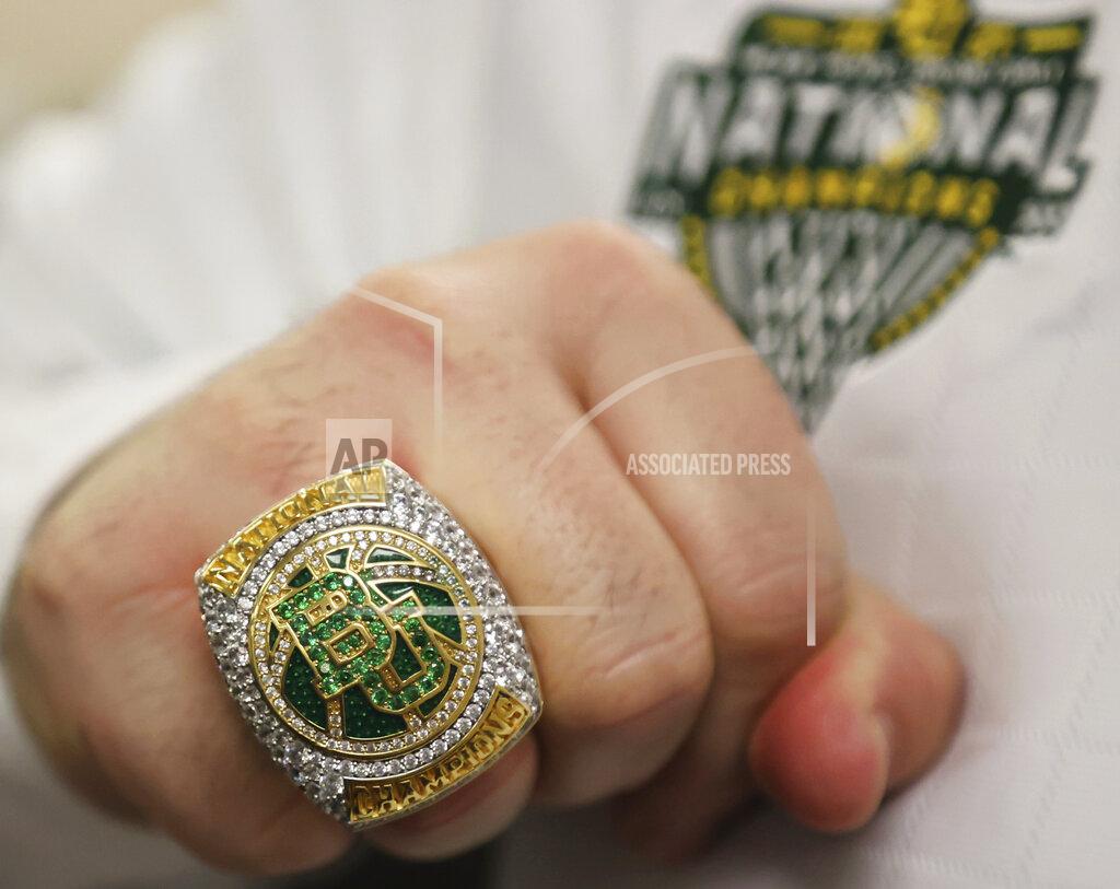 Jerry Larson A Baylor staff member displays his 2021 NCAA basketball national championship ring before an NCAA college basketball game against Incarnate Word, Friday, Nov. 12, 2021, in Waco, Texas. (Jerry Larson/Waco Tribune-Herald via AP)