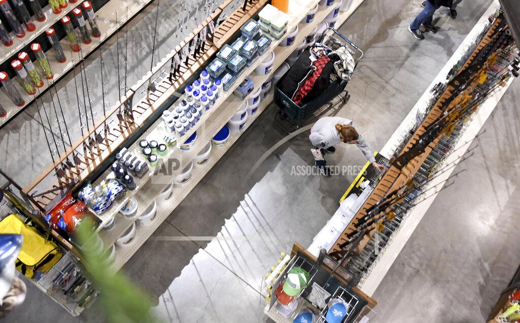 Mark Stockwell / The Sun Chronicle A shopper persuses fishing rods during Black Friday sale at Bass Pro Shops in Foxboro, Mass., Friday, Nov. 27, 20202. The outdoor specialty store opened their doors at 5 a.m. (Mark Stockwell /The Sun Chronicle via AP)