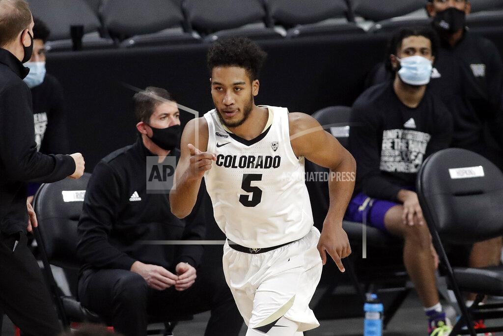 Isaac Brekken Colorado's D'Shawn Schwartz reacts after sinking a 3-point shot during the first half of an NCAA college basketball game against Washington, Sunday, Dec. 20, 2020, in Las Vegas. (AP Photo/Isaac Brekken)