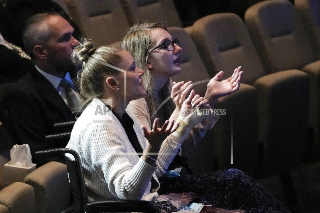 Rebecca Blackwell Angela Gonzalez, left, and daughter Deven Gonzalez sing in prayer during the funeral service for their late husband and father Edgar Gonzalez, 44, who was killed last month in the Champlain Towers South condominium collapse, on Friday, July 23, 2021, at Christ Fellowship church in Palmetto Bay, Fla. Angela and Deven were injured but survived the collapse, falling multiple stories.(AP Photo/Rebecca Blackwell)