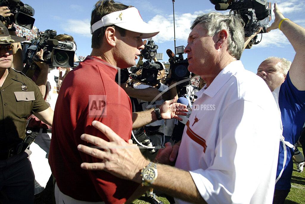 Matt Slocum FILE - In this Oct. 8, 2005, file photo, Texas coach Mack Brown, right, greets Oklahoma coach Bob Stoops after the Longhorns 45-12 win in Dallas. The annual Texas-Oklahoma rivalry game in Dallas decided the Big 12 more often than not. Both teams were nationally ranked in nine of the ten meetings. Oklahoma won the first five from 2000-04 but Texas bounced back by winning four of the last five. (AP Photo/Matt Slocum, FIle)