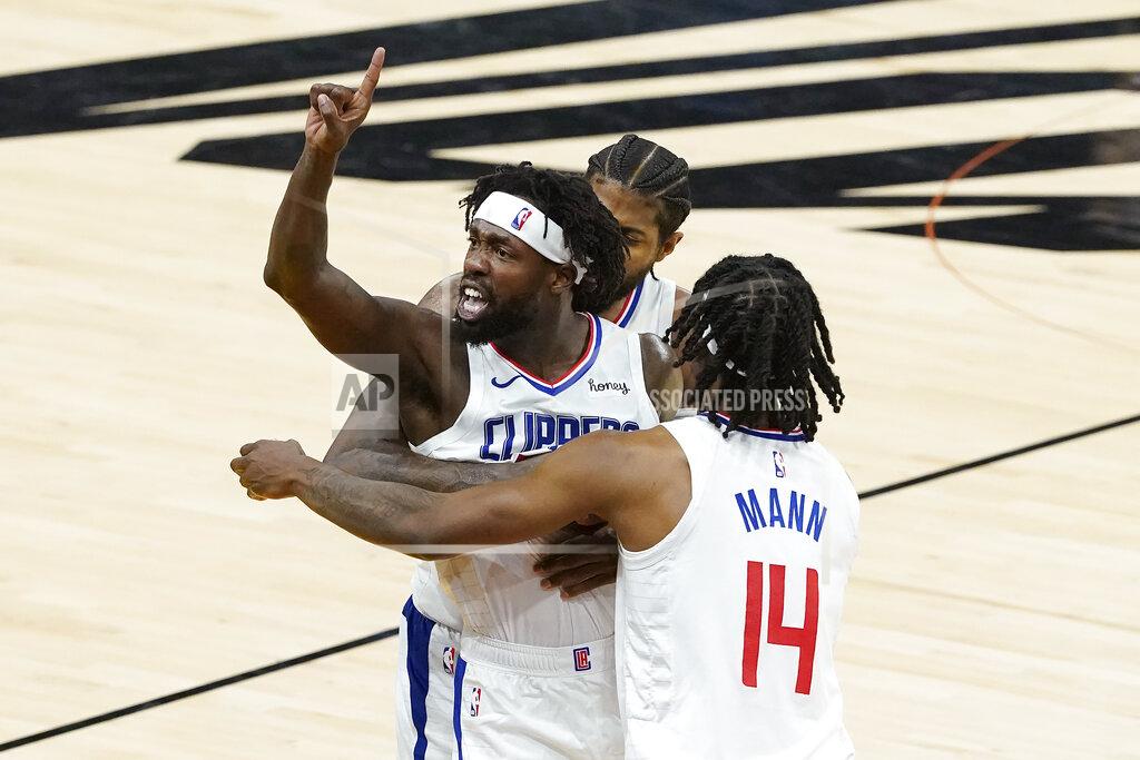 Matt York Los Angeles Clippers guard Patrick Beverley, middle, gestures toward fans while celebrating with Paul George, rear, and Terance Mann (14) during the second half of Game 2 of the NBA basketball Western Conference Finals against the Phoenix Suns, Tuesday, June 22, 2021, in Phoenix. (AP Photo/Matt York)