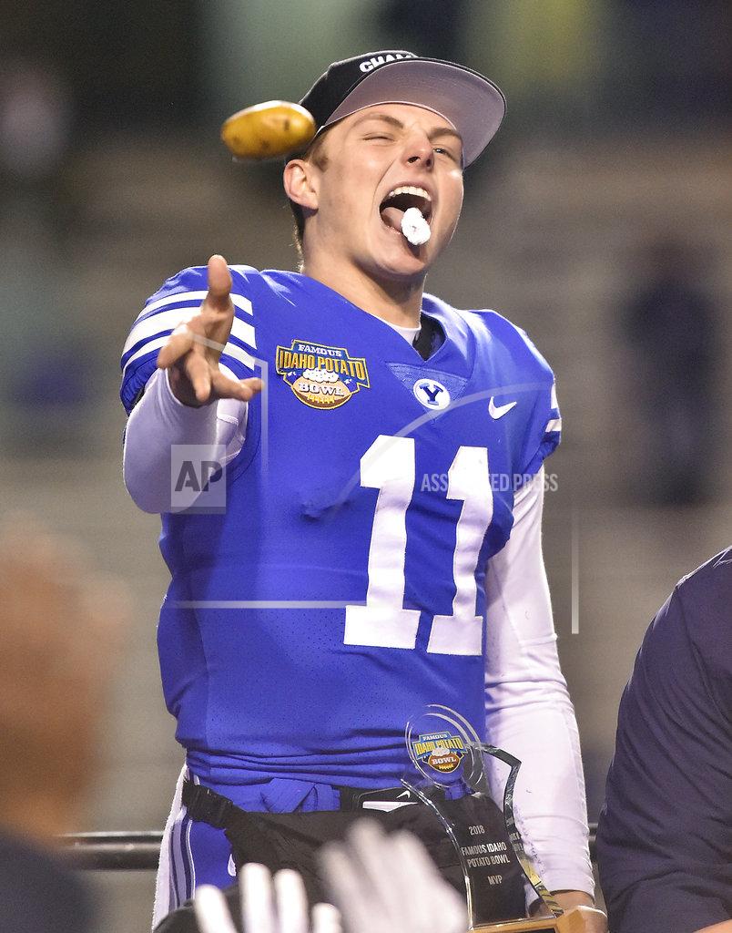 Drew Nash BYU quarterback Zach Wilson (11) bites off a piece of potato and tosses the remainder to the crowd after receiving the MVP trophy after the Famous Idaho Potato Bowl NCAA college football game against Western Michigan on Friday, Dec. 21, 2018, in Boise, Idaho. BYU won 49-18. (Drew Nash/The Times-News via AP)